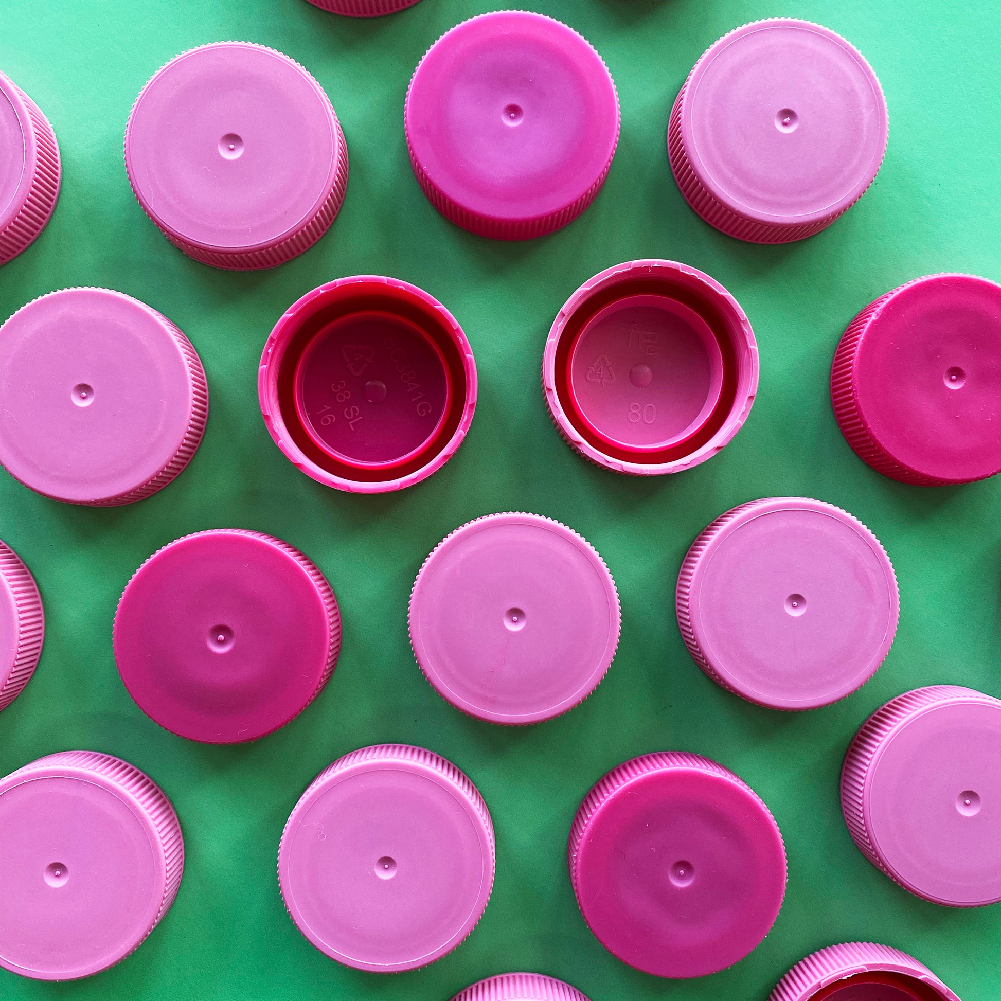 Granulated pink plastic bottle lids