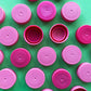 Granulated pink plastic bottle lids
